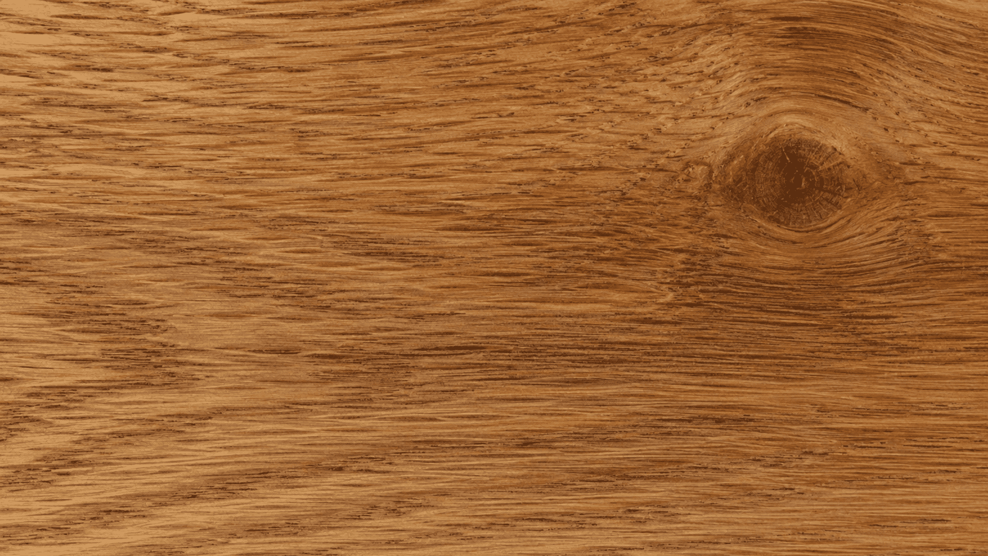 close view of natural wood grain texture with swirling patterns and a dark knot on polished timber surface