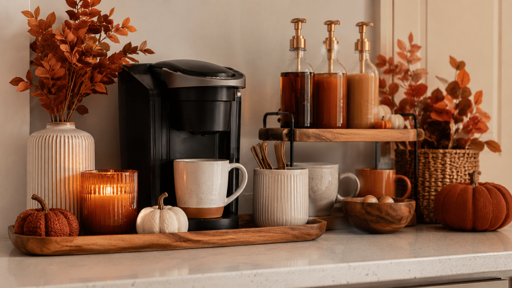 cozy fall coffee station with mugs candle pumpkins and warm tones on a kitchen counter inviting autumn feel