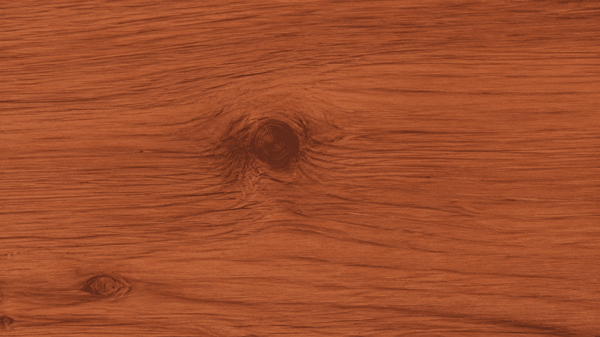 deep reddish brown wood texture with flowing grain patterns and several dark natural knots across the surface