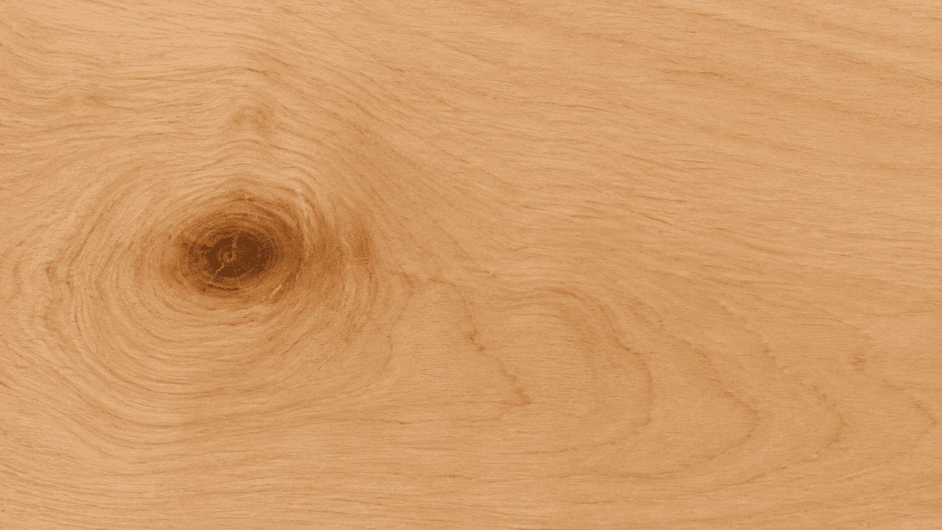 light wood surface with soft natural grain patterns and a dark circular knot near the left side