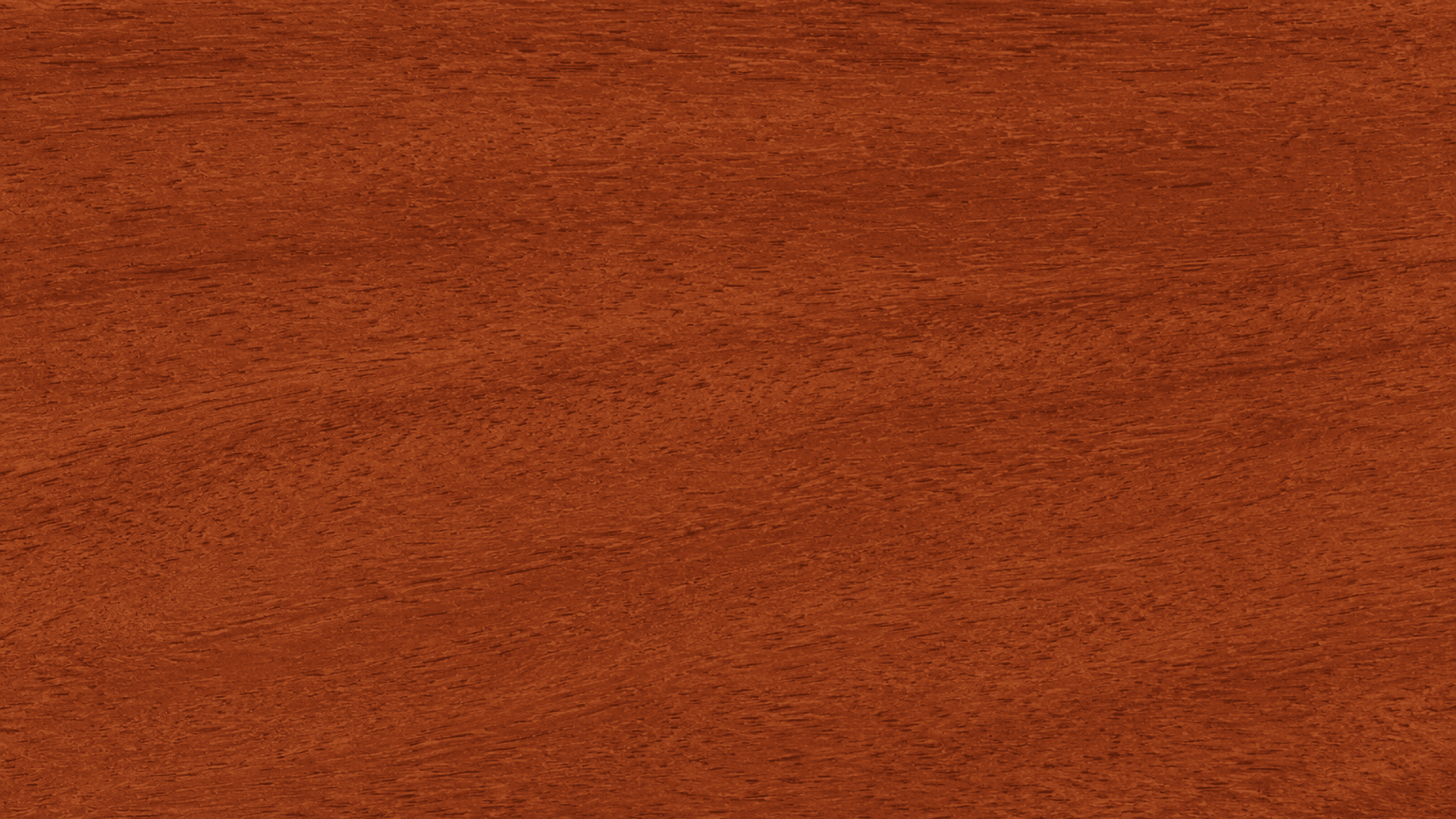 rich reddish brown wood texture with fine natural grain patterns across a smooth polished wooden surface