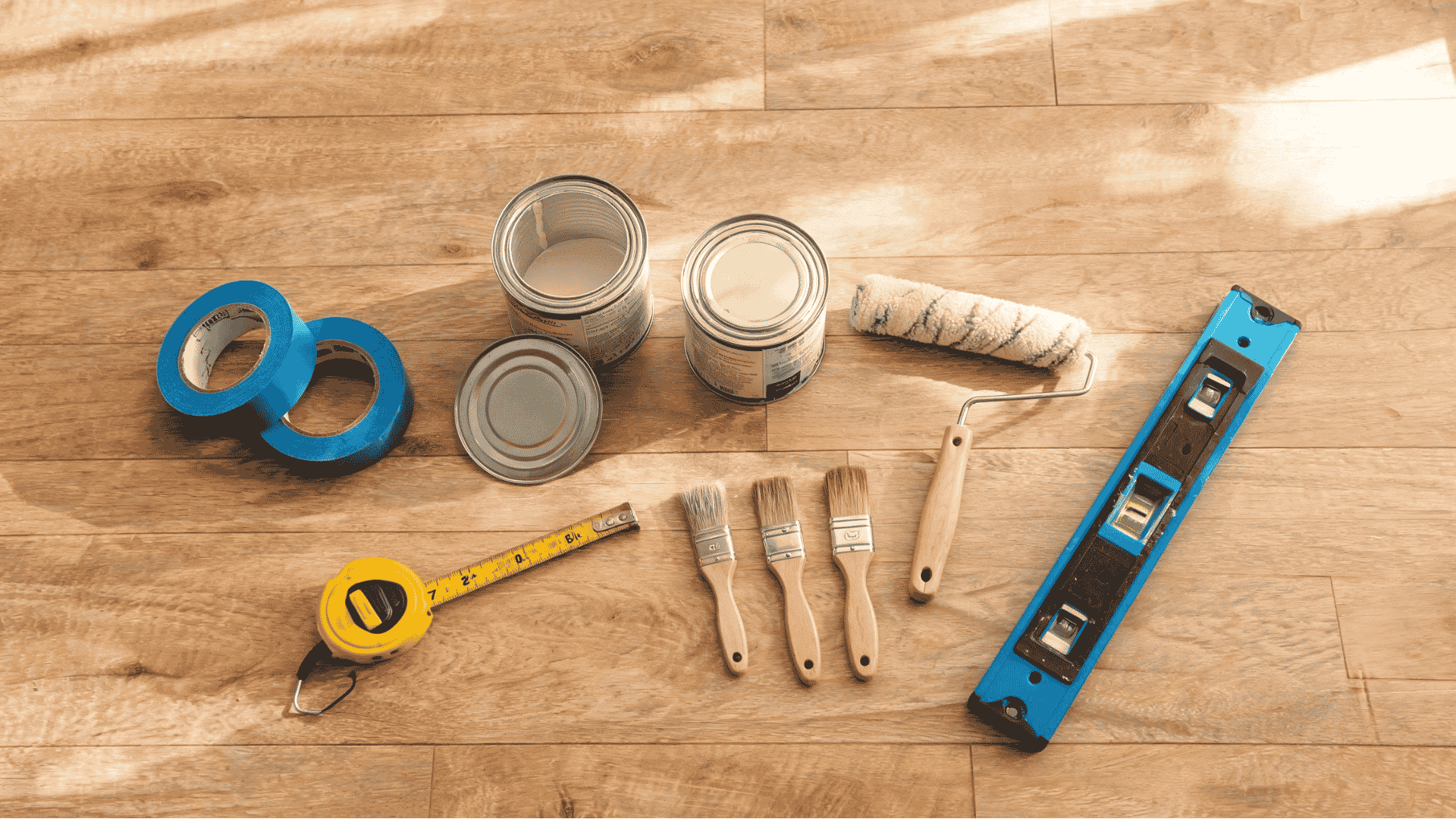 diy painting tools and materials on a wooden floor