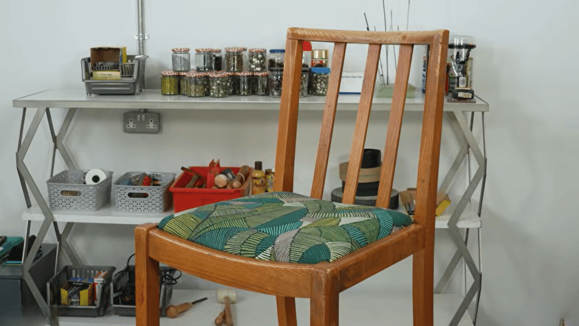finished chair with patterned cushion after reupholster dining chairs in workshop
