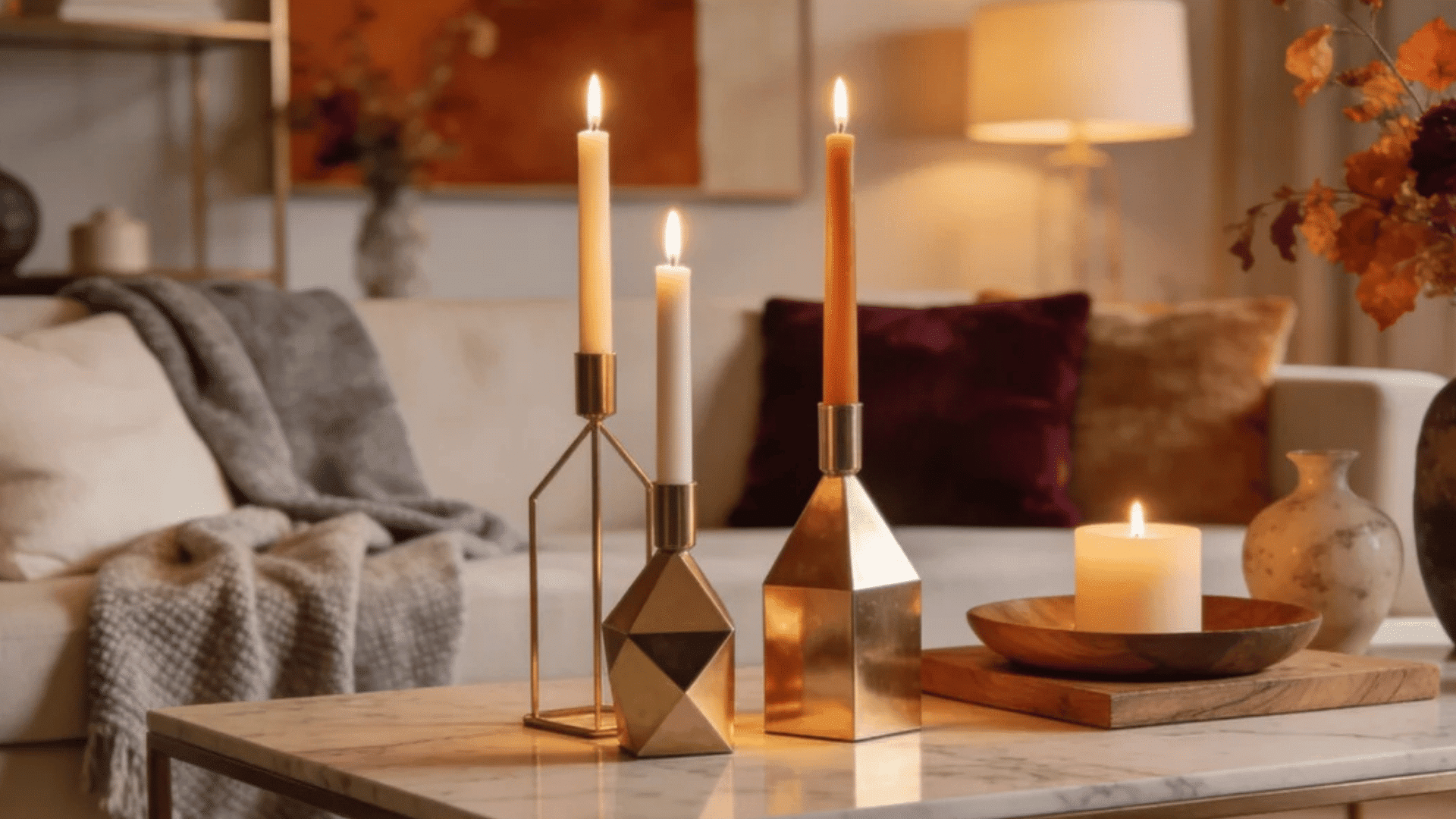 modern fall living room with gold candle holders cozy blankets and warm autumn floral decor accents