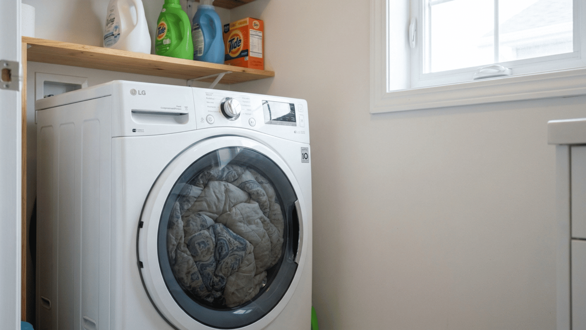 bulky queen comforter crammed tightly into a small front loading washer with no room to tumble